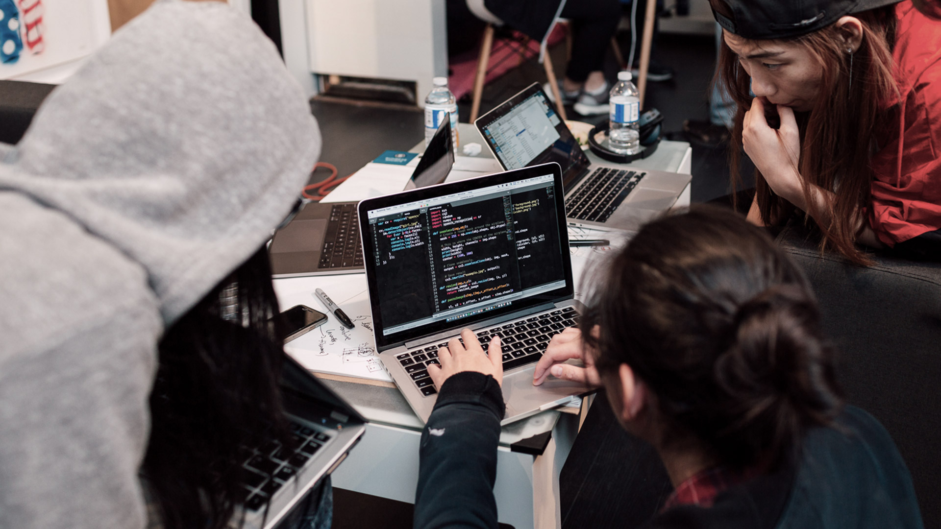 three women looking at a computer screen