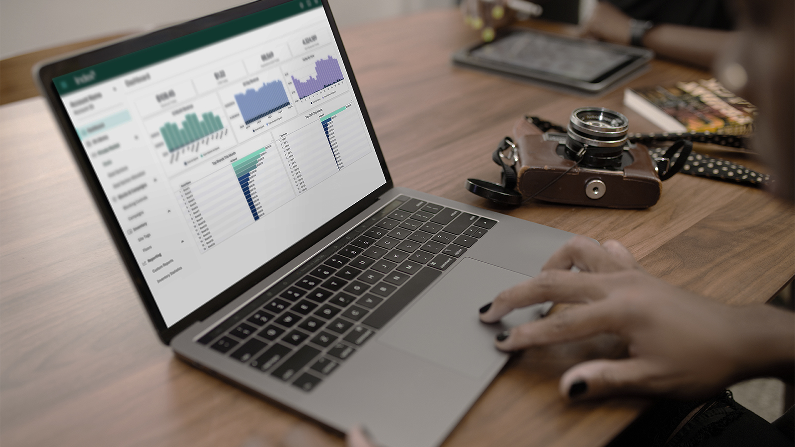 Laptop on a desk with graphs on the screen data and analytics