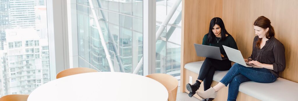 Two women meeting in high rise office