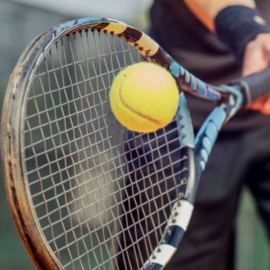 Tennis ball hitting raquet