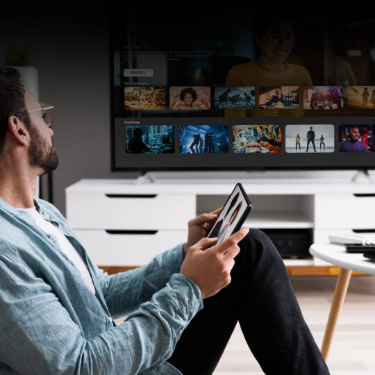 Person watching streaming tv Optimize Programmatic Monetization in Streaming TV