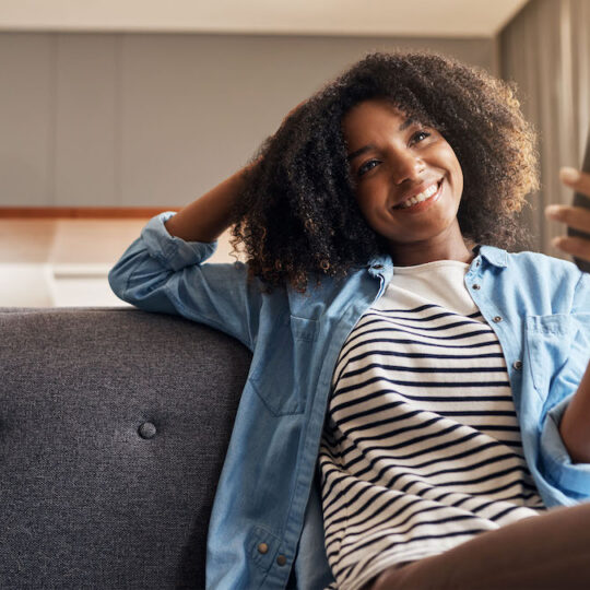 woman holding tv remote