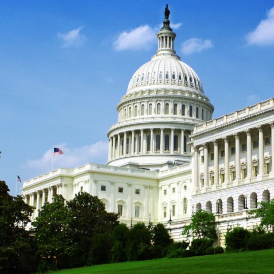 White house against a blue sky to represent political ads and streaming tv