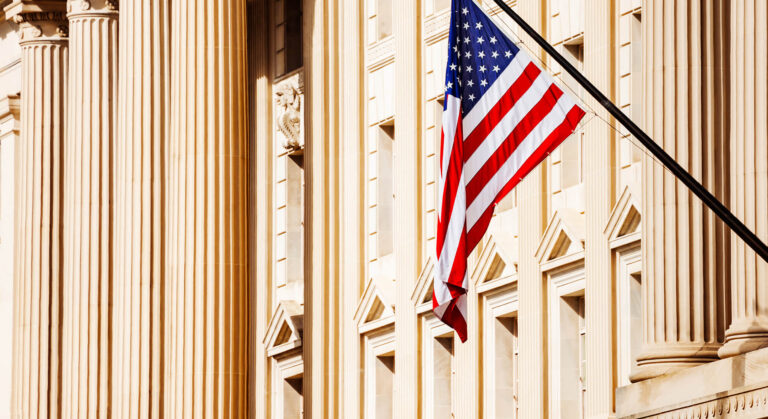 American flag against buildings