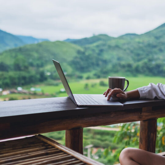 Woman outside on laptop