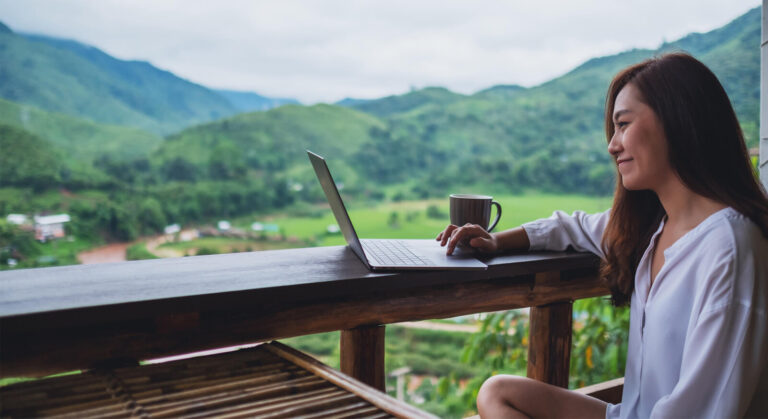 Woman outside on laptop