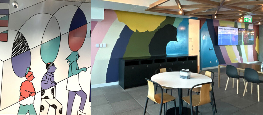 Colorful illustrations of people walking upstairs (left) and wall artwork behind a workplace kitchen (right)