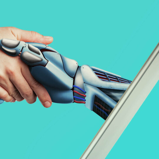 Human hand shaking hands with a robotic hand emerging from a laptop screen. Teal background.