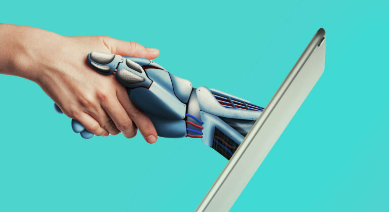 Human hand shaking hands with a robotic hand emerging from a laptop screen. Teal background.