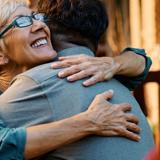 A mother embracing her son