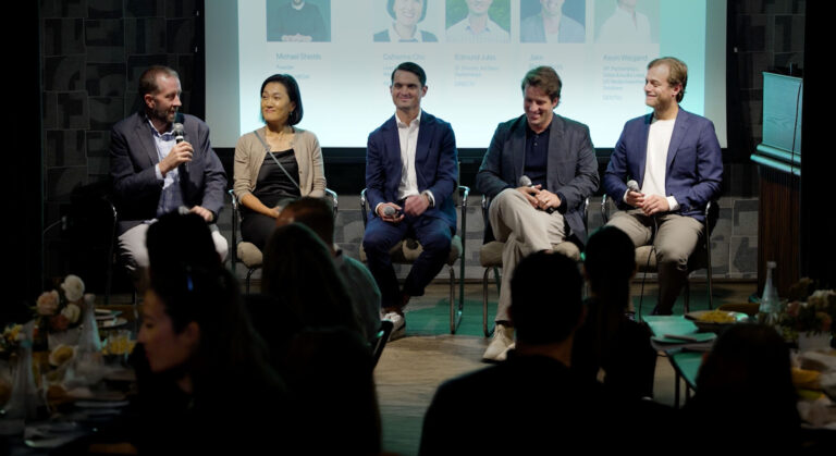 A panel of people speaking at Ad Breakfast