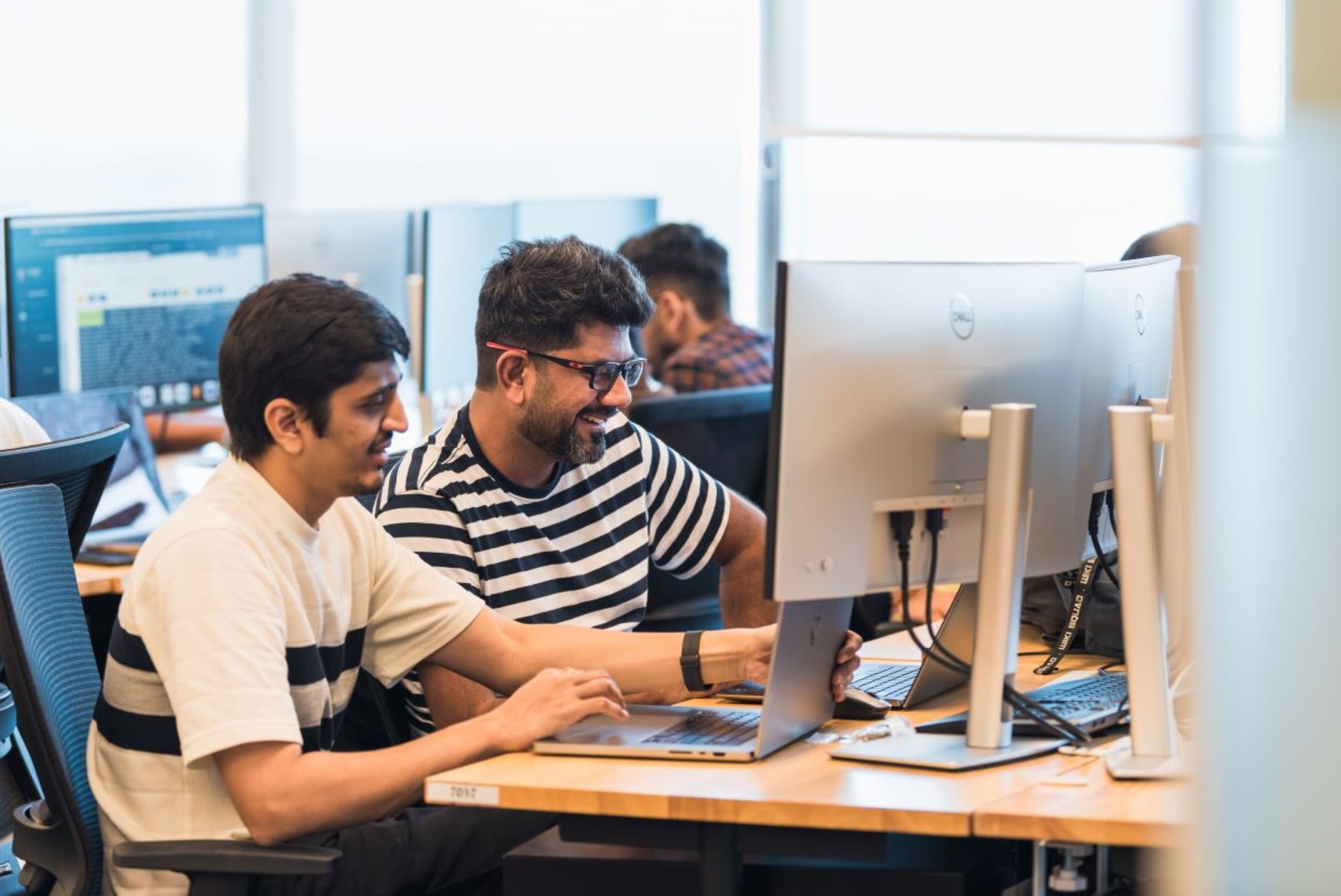 Two employees working together on the computer