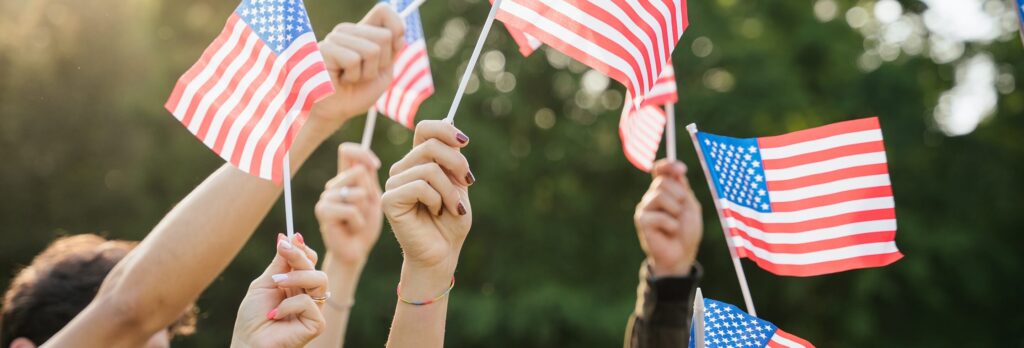 hands holding USA flags
