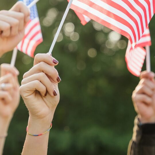hands holding USA flags