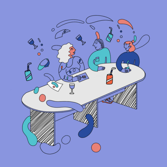 Three people sitting at a table.